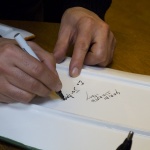 Signing works for his fans.